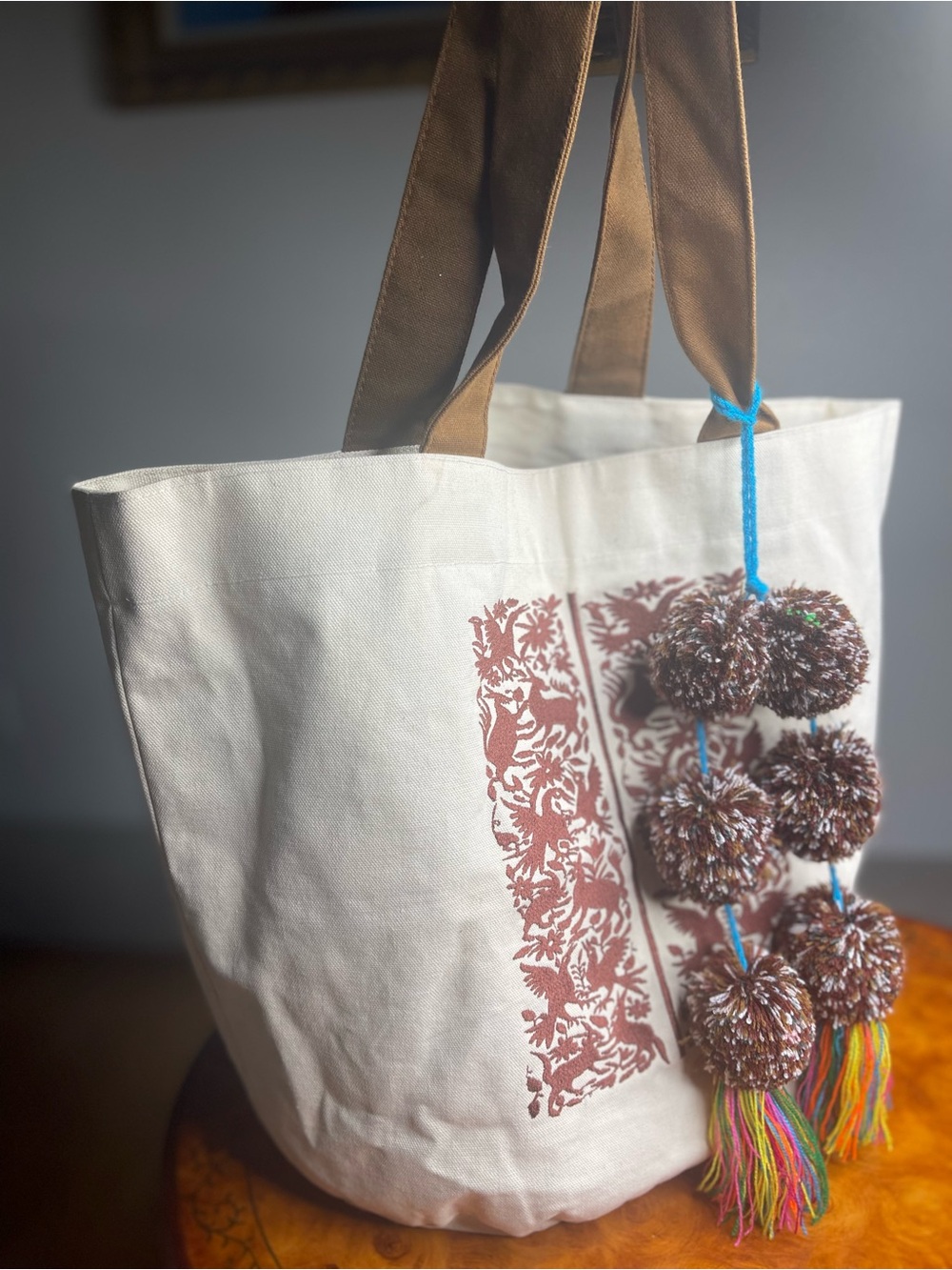 Cream Canvas Tote with Brown Straps and Colorful Pom-Pom Tassels